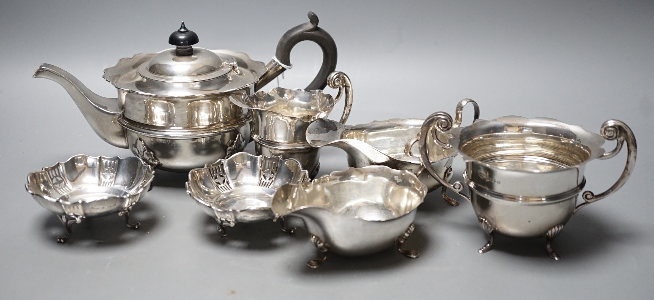 Small silver including tea pot, cream and sugar, two sauceboats and a pair of small dishes, 29.9oz.